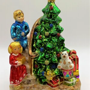 Glassware Die Kinder legen die Geschenke unter den Christbaum