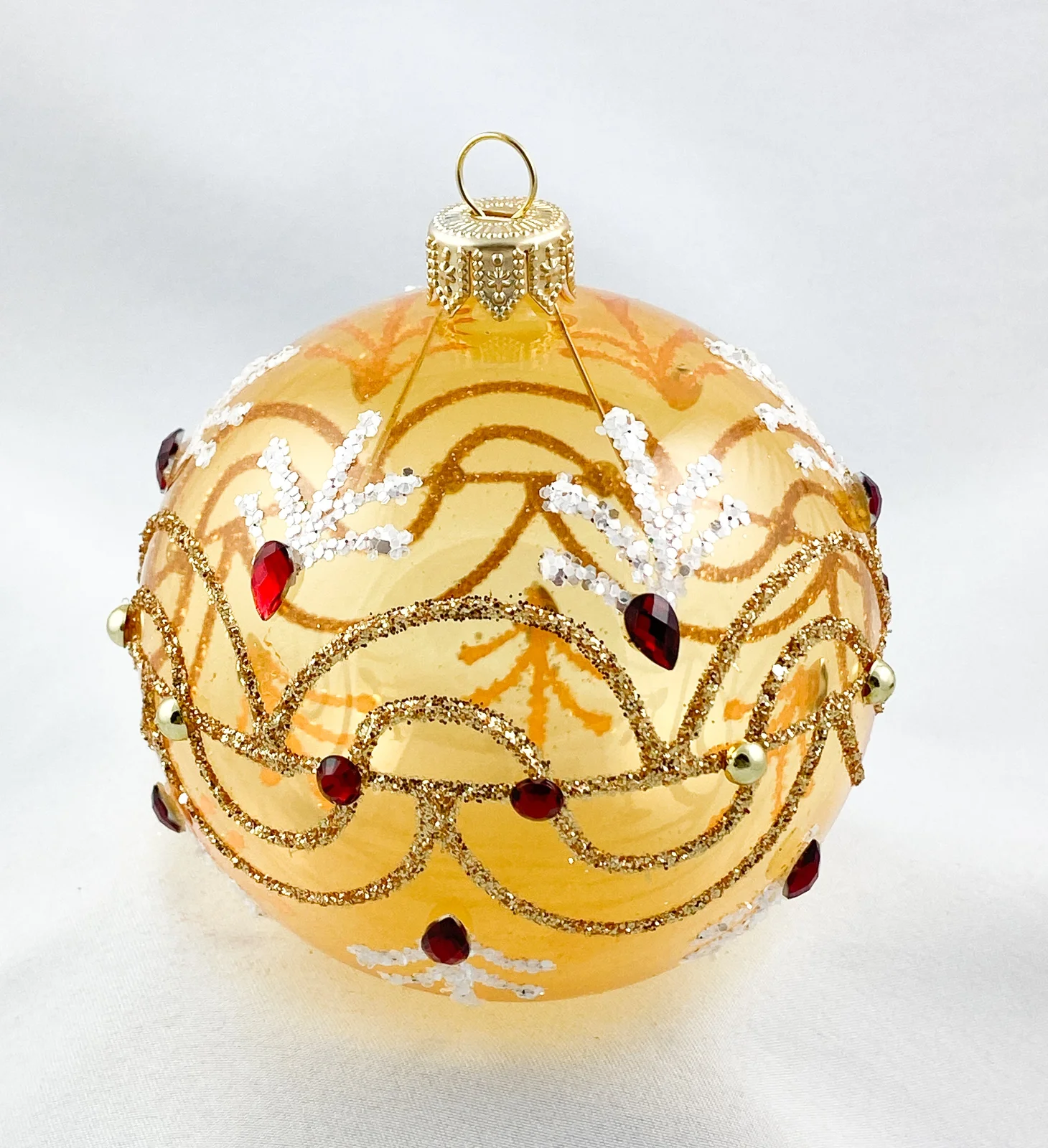 Dagmara Kugel gold transparent mit Wellenmotiv und roten Steinen