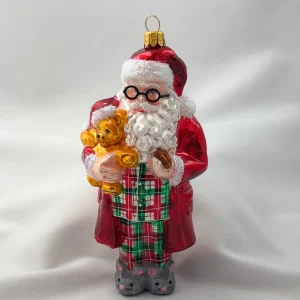 Impuls Santa hat es sich mit dem Teddy-Bär in Mäuse-Pantoffeln und Pyjama gemütlich gemacht
