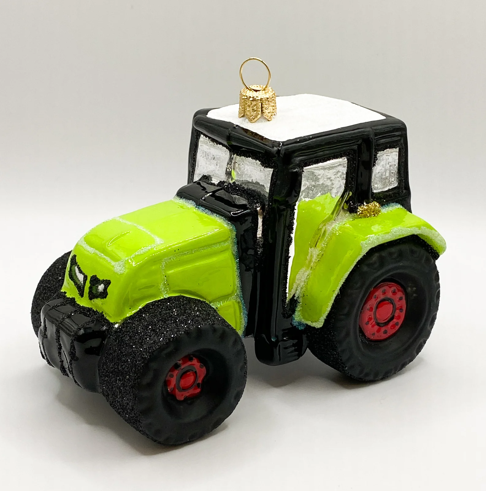 Impuls Grüner Traktor mit roten Rädern