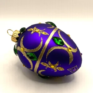 GMC Ei-Form violett mit goldenem Dekor und grünen Schmucksteinen