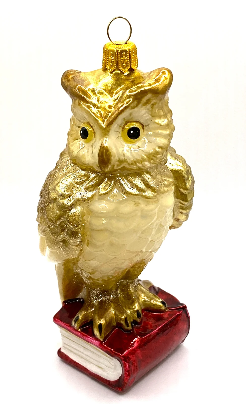 Komozja Eule mit goldenen Federn sitzt auf einem roten Buch, KOMOZJA MOSTOWSKI