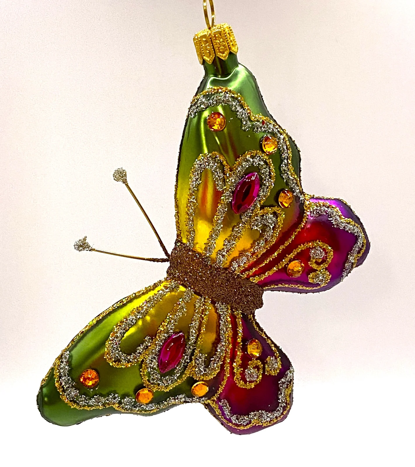 Hanco Schmetterling mit grün und pinken Flügeln mit Schmucksteinen