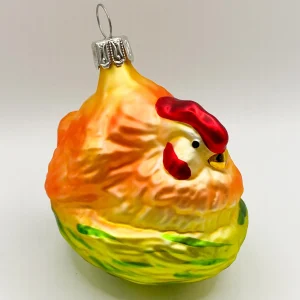Sonstige Oranges Huhn sitzt im Nest