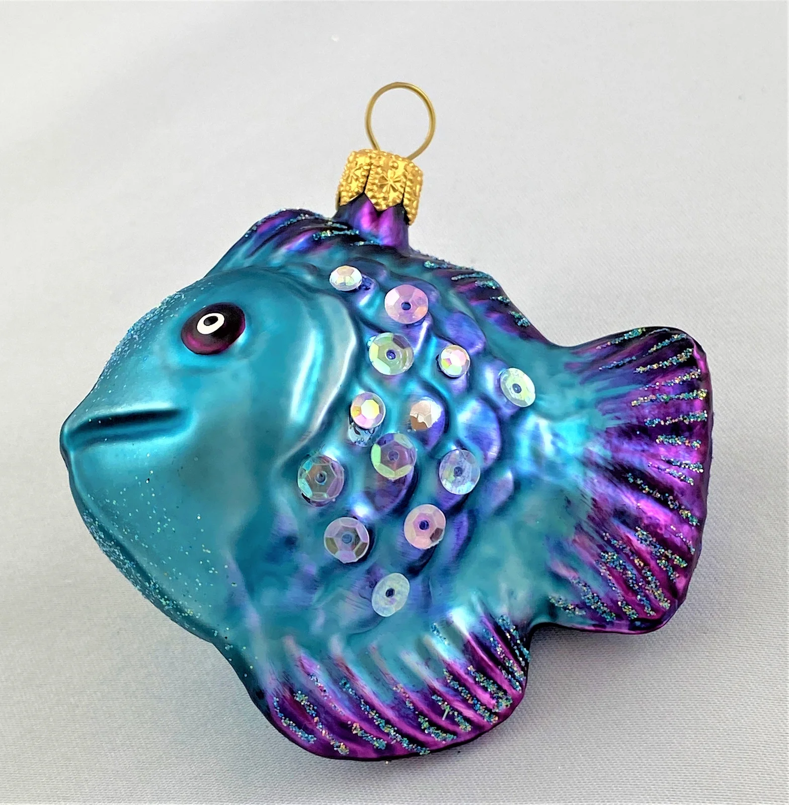 GMC Fisch türkis violett