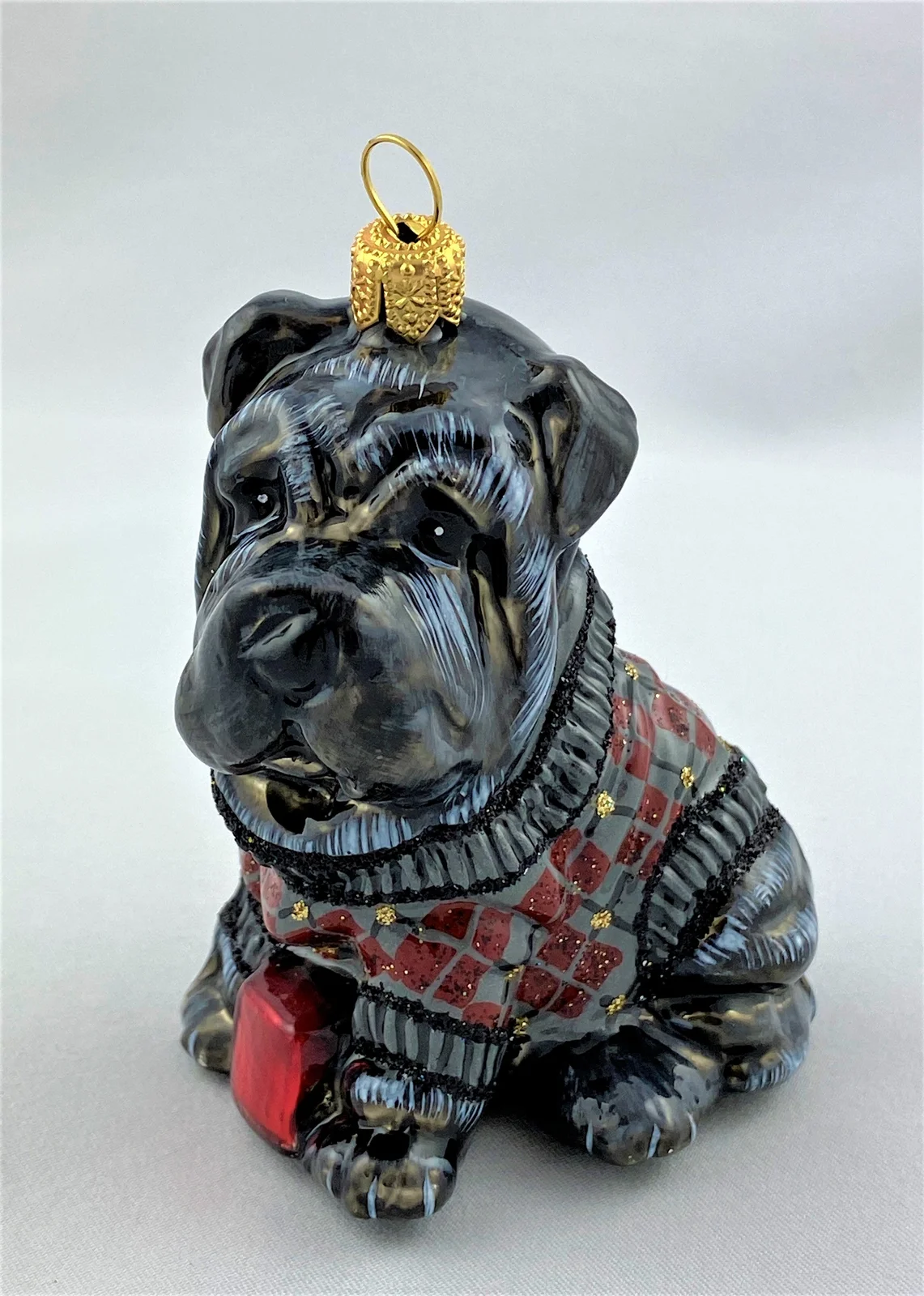 Komozja Schwarzer Sharpei im Karopullover, KOMOZJA MOSTOWSKI