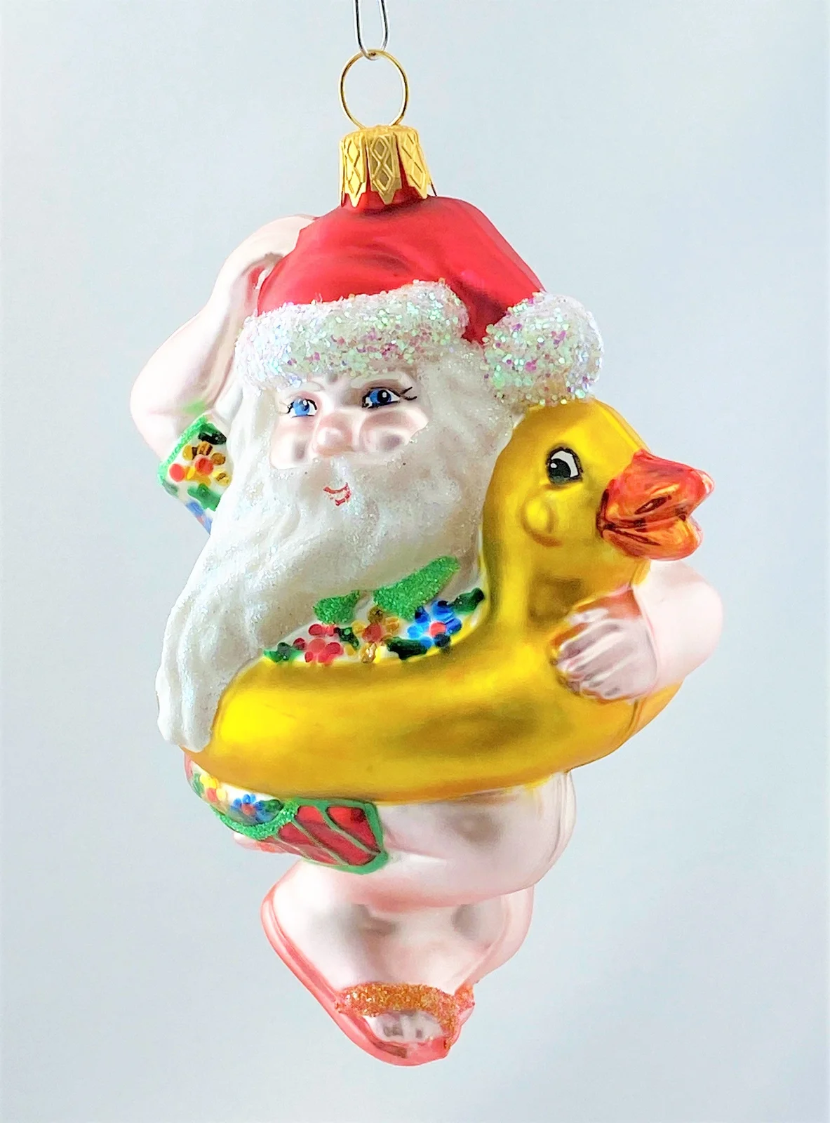 Glaspol Weihnachtsmann geht mit Enten-Schwimmring baden